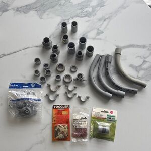 Assorted Gray PVC Electrical Conduit Fittings and Clips